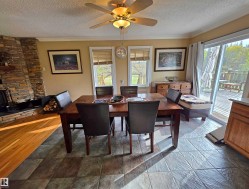 Dining Area with ceramic tile flooring, ceiling fan with integrated lighting, and sliding glass door leading to a wood deck - 