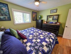 Hardwood flooring, ceiling fan, white trim window, painted interior wall, white door - 