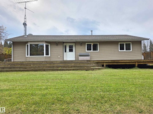 Ranch-style exterior with neutral siding, a bay window, and a full-width wooden deck - 9131 Township Road 554, Rural St. Paul County, AB 