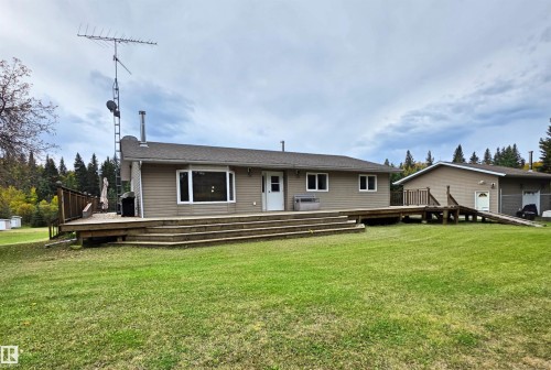 Exterior featuring neutral-toned siding, a wood deck, & a bay window - 9131 Township Road 554, Rural St. Paul County, AB 