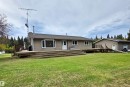 Exterior featuring neutral-toned siding, a wood deck, & a bay window - 9131 Township Road 554, Rural St. Paul County, AB 