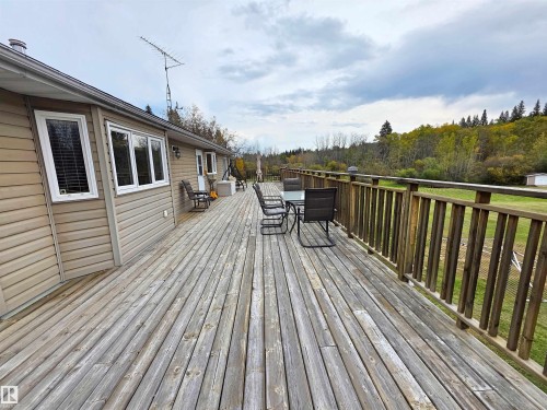 Expansive wood deck with a perimeter railing, south facing side - 9131 Township Road 554, Rural St. Paul County, AB 