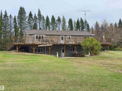 Expansive elevated wood deck with perimeter railing - 