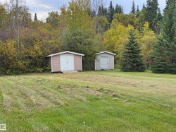 Two detached storage sheds with siding exteriors - 