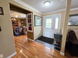 Wood-finish flooring, built-in shelving & crown molding - 