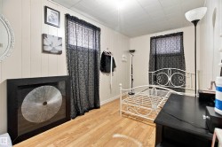 Wood-finish flooring with white vertical paneling - 