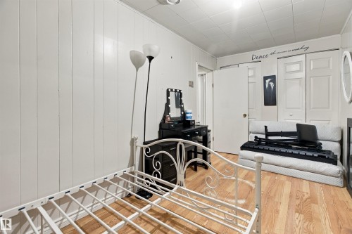 Wood-finish flooring with white paneled walls - 12707 73 Street Nw, Edmonton, AB 