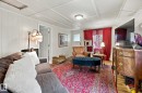 Spacious multipurpose room featuring hardwood flooring, white paneled walls, and recessed ceiling lighting - 12707 73 Street Nw, Edmonton, AB 