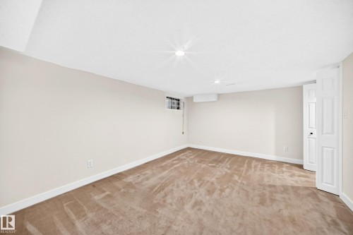 Neutral-toned carpeting, white walls, and recessed ceiling lighting - 7307 152C Avenue Nw, Edmonton, AB 