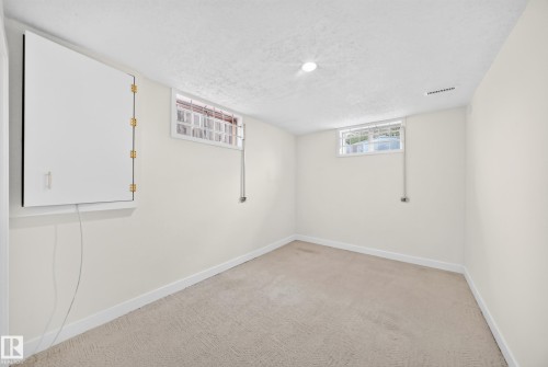 Recessed lighting, light-colored carpeting, two windows, painted walls, and white trim - 7307 152C Avenue Nw, Edmonton, AB 