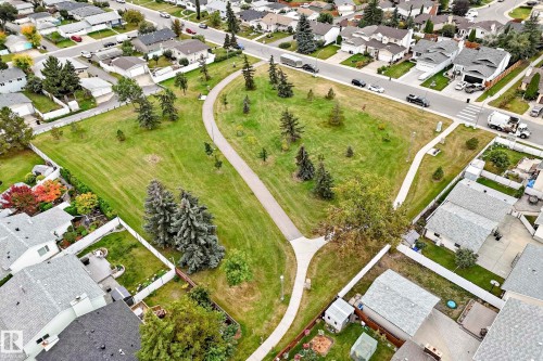 Expansive green space with walking paths, mature trees, and residential surroundings - 7307 152C Avenue Nw, Edmonton, AB 