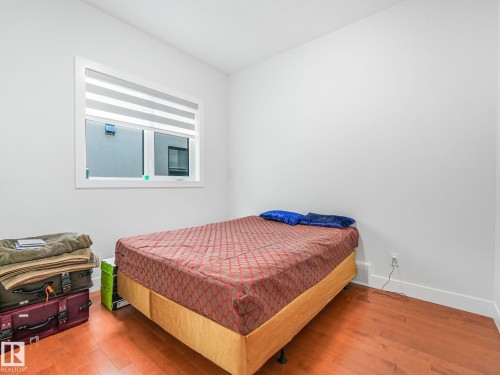 Hardwood flooring, painted walls, window with blinds, and white trim - 120 38 Street Sw, Edmonton, AB 