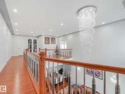 Wood-finish flooring with a modern wood and metal railing - 