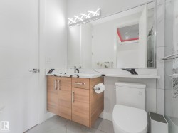 Floating wood-finish vanity with a white countertop, under-mount sink, and contemporary wall-mounted lighting - 