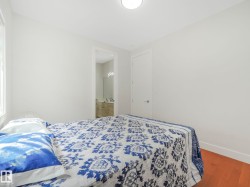 Recessed lighting, wood-finish flooring, white walls, and white trim - 
