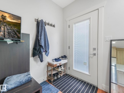 Entry door with a privacy pane and polished chrome hardware - 120 38 Street Sw, Edmonton, AB 