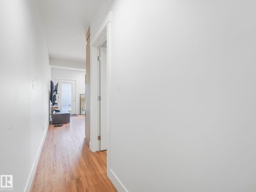 Hardwood-finish flooring, white walls, and a white interior door - 120 38 Street Sw, Edmonton, AB 
