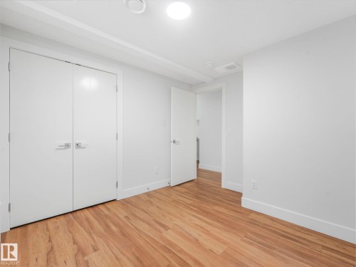 Wood-finish flooring, white walls, and a ceiling-mounted light fixture - 120 38 Street Sw, Edmonton, AB 