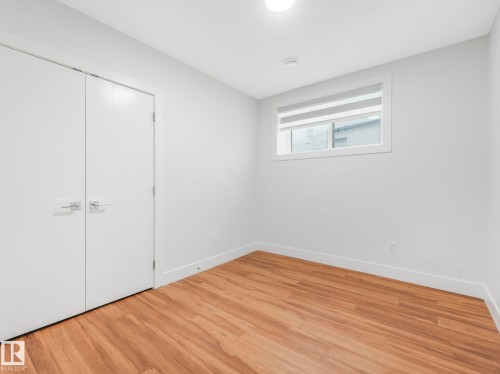 Wood-finish flooring, white walls, and a window with blinds - 120 38 Street Sw, Edmonton, AB 