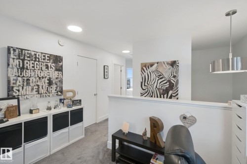 Recessed ceiling lighting, durable flooring, white walls, and a contemporary pendant light fixture - 153 Cavanagh Common Sw, Edmonton, AB 