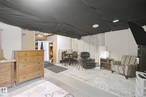 Recessed lighting, concrete flooring, exposed ceiling joists, and white wall finishes - 153 Cavanagh Common Sw, Edmonton, AB 