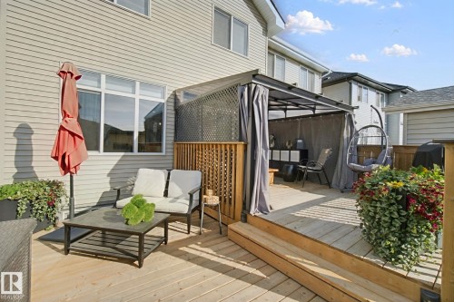 Expansive wood decking with a privacy screen, covered gazebo, and exterior siding - 153 Cavanagh Common Sw, Edmonton, AB 
