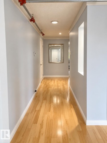 Hardwood flooring, recessed ceiling lighting, light gray wall paint, and white trim molding - 18929 99A Avenue Nw, Edmonton, AB 