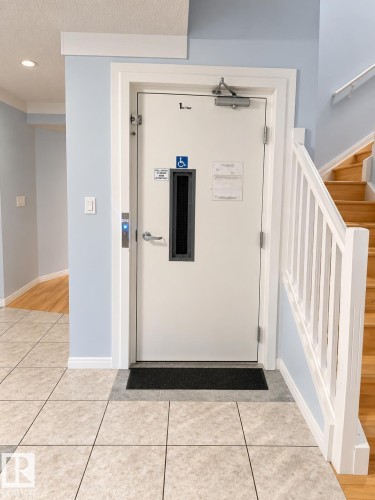 Hardwood staircase with white risers and railings - 18929 99A Avenue Nw, Edmonton, AB 