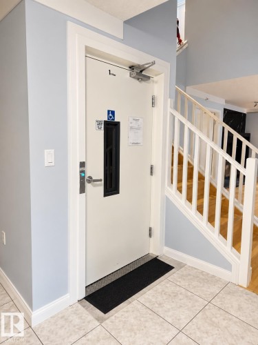 Tile flooring, white painted staircase, light blue wall paint, white trim - 18929 99A Avenue Nw, Edmonton, AB 