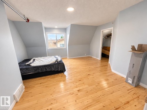 Hardwood flooring, recessed lighting, window, light blue wall paint, and an open doorway - 18929 99A Avenue Nw, Edmonton, AB 