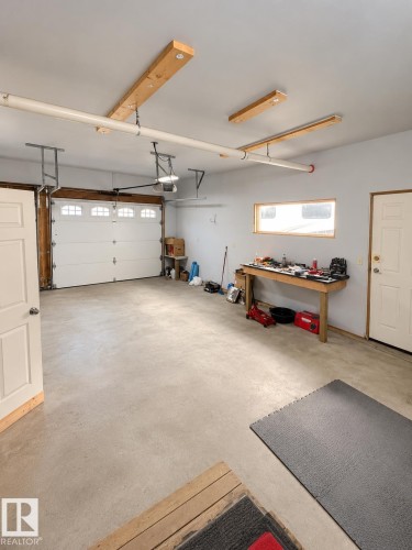 Attached garage with concrete flooring, white overhead door, and recessed lighting - 18929 99A Avenue Nw, Edmonton, AB 