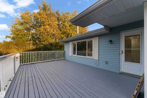 Expansive deck with painted wood flooring and white railing - 52314 Rge Road 215, Rural Strathcona County, AB 