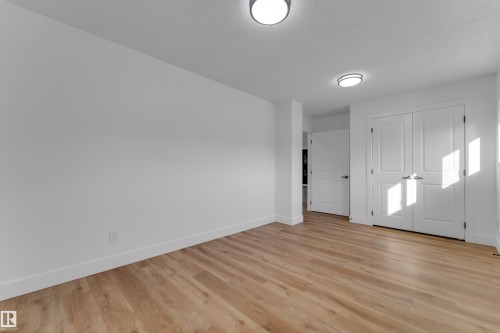 Wood-finish flooring, white walls, white doors, and flush-mount ceiling lighting - 52314 Rge Road 215, Rural Strathcona County, AB 