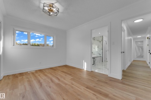 Wood-finish flooring throughout, white walls, and crown molding - 52314 Rge Road 215, Rural Strathcona County, AB 