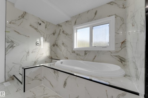 Soaking tub with surrounding tile, separate shower with tile surround, window with white trim, and white tile flooring - 52314 Rge Road 215, Rural Strathcona County, AB 