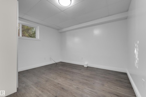 Wood-finish flooring, white walls, and a drop ceiling with recessed lighting - 52314 Rge Road 215, Rural Strathcona County, AB 