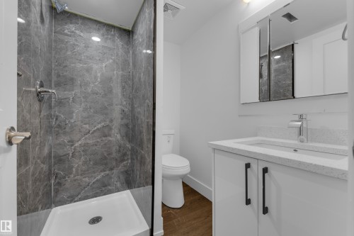 Walk-in shower with gray marbled-finish wall panels and a white shower base - 52314 Rge Road 215, Rural Strathcona County, AB 