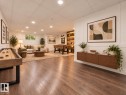 Expansive room featuring wood-finish flooring, recessed lighting, and a window for natural light - 52314 Rge Road 215, Rural Strathcona County, AB 