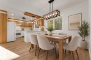 Integrated kitchen and dining area featuring wood-finish flooring, recessed lighting, and kitchen cabinetry with brushed nickel hardware - 52314 Rge Road 215, Rural Strathcona County, AB 
