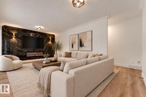 Feature wall with a built-in electric fireplace and mounted television, recessed lighting, and wall-mounted sconces - 52314 Rge Road 215, Rural Strathcona County, AB 