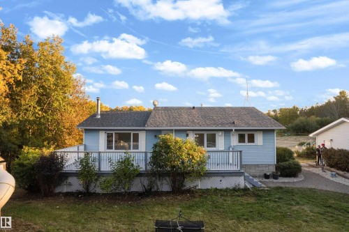 Light blue siding residence with a dark shingle roof - 52314 Rge Road 215, Rural Strathcona County, AB 
