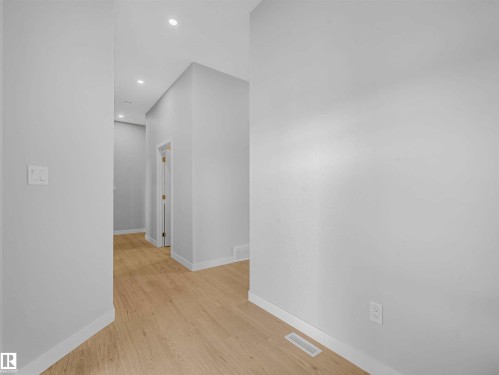 Recessed ceiling lighting, light wood-finish flooring, white trim, and light gray walls - 22 Dalquist Bay, Leduc, AB 