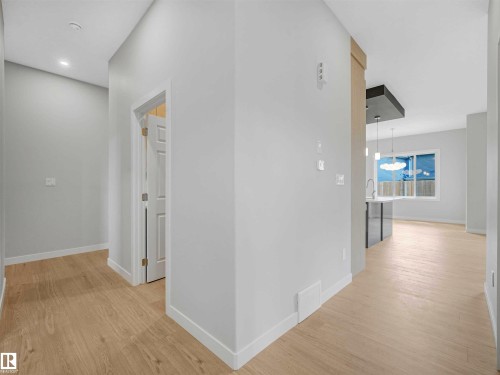 Light-toned wood-finish flooring throughout - 22 Dalquist Bay, Leduc, AB 
