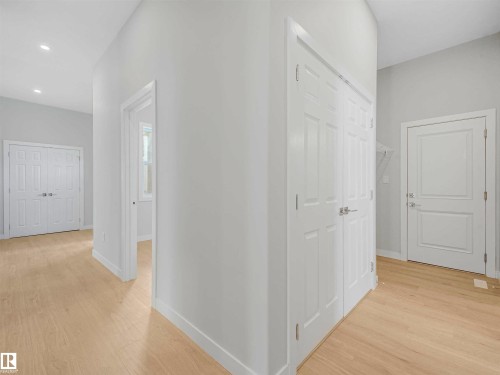 Wood-finish flooring throughout, bright white walls, recessed ceiling lighting, and panel interior doors - 22 Dalquist Bay, Leduc, AB 