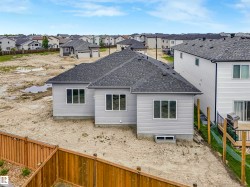 Light gray siding exterior with multiple windows and a shingled roof - 
