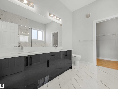 Double vanity with integrated sinks and gray cabinetry - 22 Dalquist Bay, Leduc, AB 