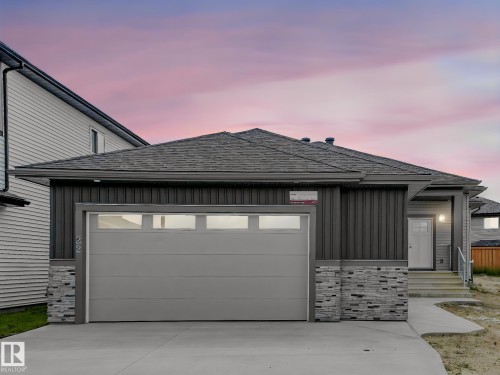 Contemporary exterior with gray siding and stone accents - 22 Dalquist Bay, Leduc, AB 
