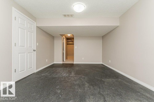 Recessed ceiling, neutral wall paint, white trim, six-panel interior door, overhead lighting fixture - 3203 Carpenter Landing Sw, Edmonton, AB 