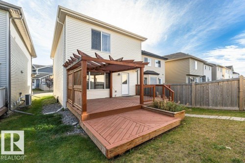 Expansive wood deck with a built-in pergola, privacy screen, and raised planter box - 3203 Carpenter Landing Sw, Edmonton, AB 