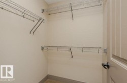 Integrated wire shelving system, neutral wall finishes, matching door and trim, dark hardware - 